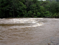 The same river chaged after rain into raging stream